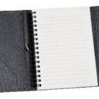 Open black leather notebook with a spiral binding. The left flap has a pocket, while the right flap is plain. The notebook contains lined white pages.