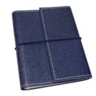 A closed, textured blue leather notebook secured with an elastic band wrapped horizontally. The notebook has white stitching along the edges, giving it a classic and elegant appearance.