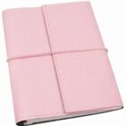 A closed pink leather notebook with a textured cover is secured with an elastic band wrapped vertically around it.