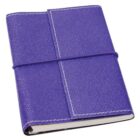 A closed notebook with a textured purple leather cover, secured by an elastic band wrapped horizontally around it. The notebook has white pages visible along the edges, and white stitching along the covers borders.