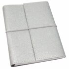 A closed journal with a textured silver cover, wrapped with a white elastic band. The journal has a minimalist design and appears to be bound in a soft, leather-like material.