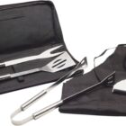 BBQ tool set including a spatula, fork, and tong, displayed with a black apron. The tools are silver with long handles, and the set is accompanied by a black carrying case.
