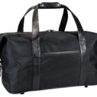 A black duffel bag with sturdy leather handles and trim is shown. It features a smooth design with a front pocket and a secure zip closure on top.