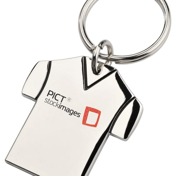 A keychain shaped like a T-shirt with the text PICT stockimages and a red square logo printed on it. The keychain is made of shiny metal and is attached to a circular key ring.