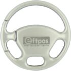 A round, light gray plastic keychain shaped like a steering wheel, with the logo and text eftpos New Zealand Limited in the center.