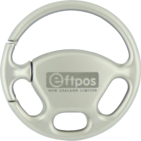 A round, light gray plastic keychain shaped like a steering wheel, with the logo and text eftpos New Zealand Limited in the center.