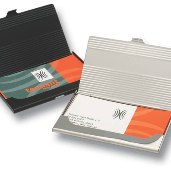 Two open metal business card holders are displayed. One is black with a card featuring a red and teal design. The other is silver with a card featuring a similar design in teal and orange.