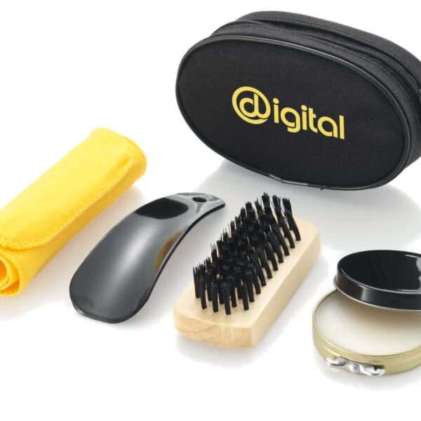 A grooming kit featuring a yellow cloth, a black shoehorn, a wooden brush with black bristles, a small black tin container, and a black zippered bag labeled Digital.