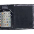 A black tablet case is open, displaying a touchscreen tablet on the left side with various app icons visible. The right side of the case is empty, featuring a smooth, black surface.