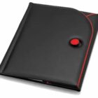 A black folder with red accents, featuring a circular red and black button closure. The folder has a sleek design with curved edges, partially opened to reveal contents inside.
