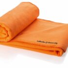 A folded orange fleece blanket with LaRoche University printed in black text on one corner. The blanket is neatly rolled on one end and flat on the other, displayed against a white background.