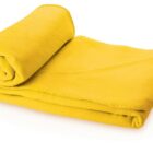 A bright yellow, plush fleece blanket partially rolled and folded neatly, with soft rounded edges, isolated on a white background.