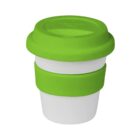 A collapsible, reusable coffee cup with a white base and bright green silicone lid and sleeve. The compact design suggests portability and eco-friendliness. The lid is snugly fitted, suitable for on-the-go use.