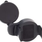 A black handheld device with a circular body and a rotating lid. The lid is open, revealing a flat surface inside. The device features a small clip on the side, possibly for attaching or securing.