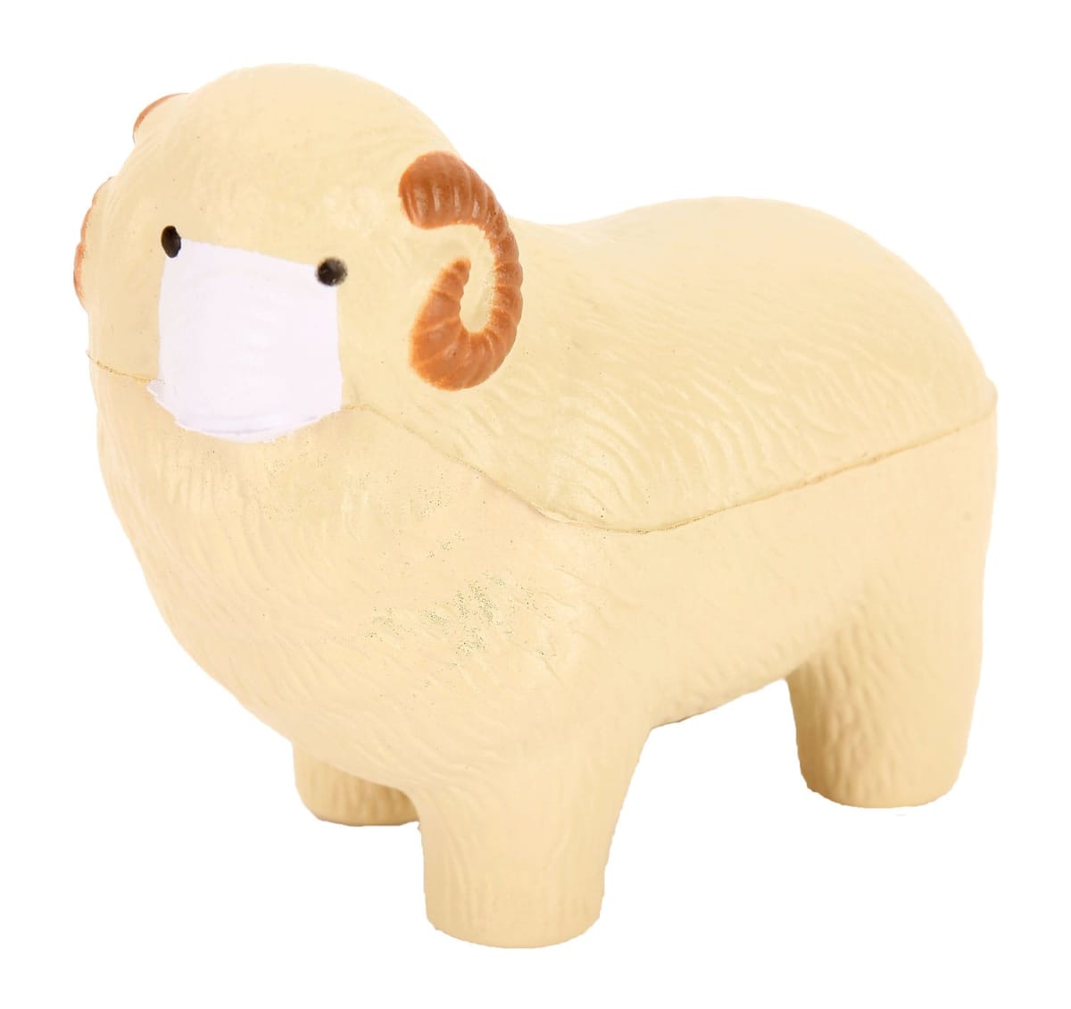 A small, cute toy ram with tan wool and curved brown horns is wearing a white face mask. The background is plain white.