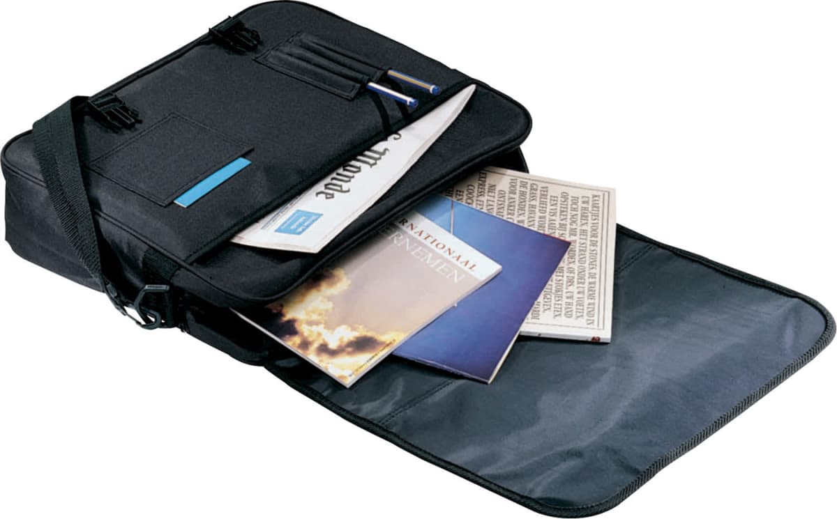 Open black messenger bag with a shoulder strap, containing a newspaper, a magazine, and a pen. The flap is fully open, and other papers are visible inside. The bag is resting against a white background.
