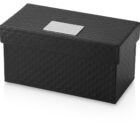 A black, rectangular, quilted storage box with a lid. It has a diamond pattern and features a rectangular, metallic label holder on the top center. The box is shown against a plain white background.