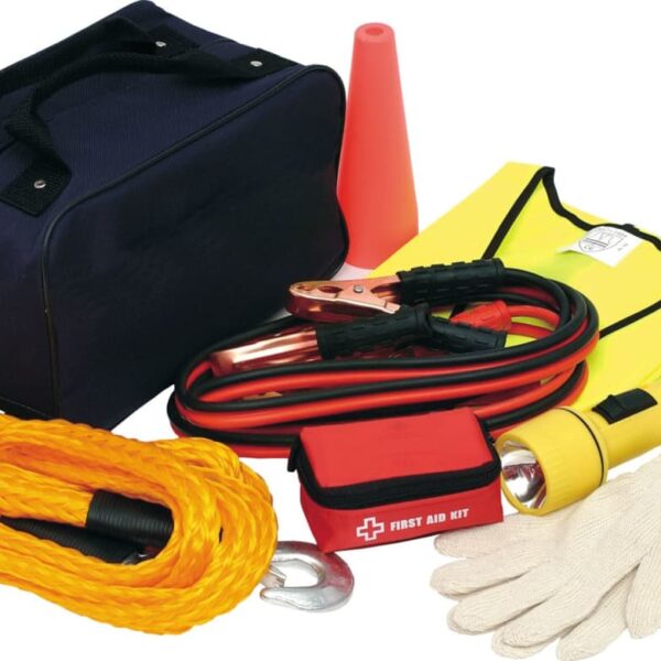 A roadside emergency kit including a black bag, orange cone, yellow safety vest, jumper cables, yellow rope, flashlight, red first aid kit, gloves, and plastic pouch.