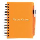 Orange spiral-bound notebook with Manila Grace written on the cover. A pen is held in a loop attached to the notebook.