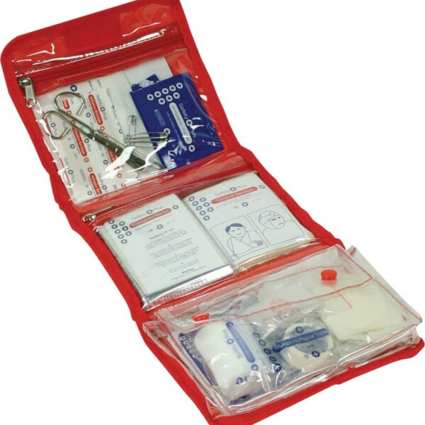 A red first aid kit is open, displaying various medical supplies. It includes bandages, antiseptic wipes, a pair of scissors, and instruction booklets, all organized in transparent compartments for easy access.