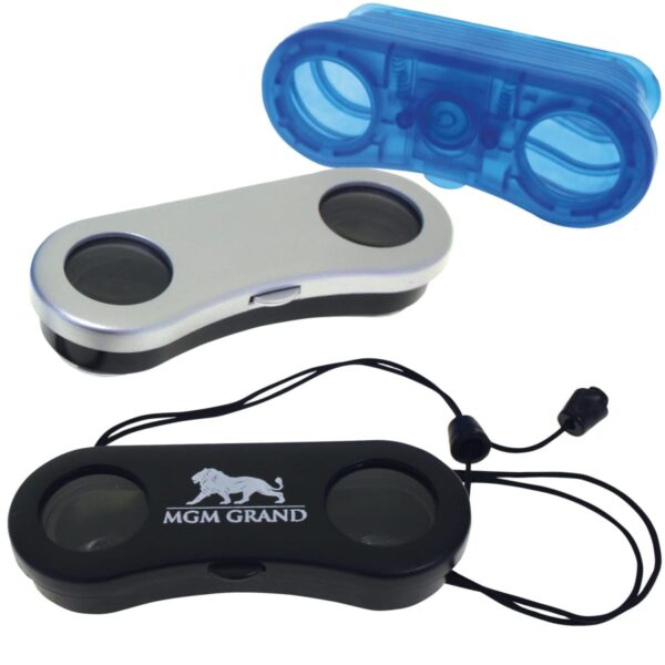 Three compact binoculars are shown: one with a silver finish, another in black with MGM Grand and a lion logo, and a third in translucent blue. The black binoculars include a neck strap with an adjustable toggle.