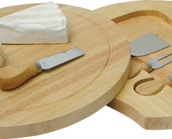 Wooden cheese board set with a round surface featuring two cheese knives and a fork, accompanied by a wedge of brie and a round cheese. A compartment underneath holds the utensils.