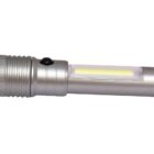 A silver flashlight with a textured grip and a clear section revealing an illuminated LED bulb. It has a black button on its side and a metallic finish.