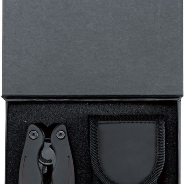 A black multi-tool and its matching black nylon pouch are neatly placed side by side in a black foam-lined box. The box lid is propped open, revealing the items inside.