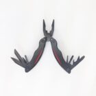 A black multi-tool with red accents displayed on a white background. It features a pair of pliers, a knife blade, and other foldable tools extended slightly open.