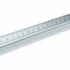 A silver triangular architects scale ruler with measurement markings. The ruler is angled, showing its three sides, typically used for architectural drafting and precise measurements.