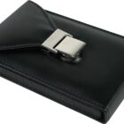 A sleek black leather wallet with a shiny metal clasp is closed and resting on a white surface. The wallet has a smooth finish and a subtle stitching detail along the edges, highlighting its elegant design.