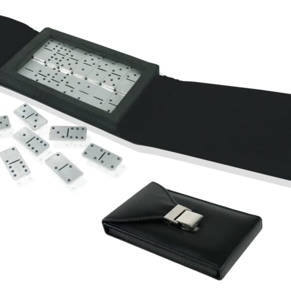 A set of dominoes is spread out on a white surface. Some dominoes are scattered, while others are neatly placed in a black, open case with a silver clasp. A closed case is positioned in front of the open case.