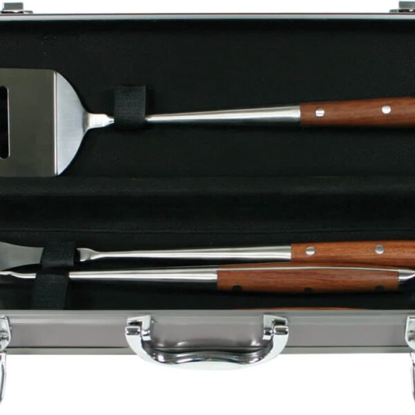 A metal case containing a barbecue tool set with two utensils: a spatula and a fork, each having stainless steel heads and wooden handles. The interior of the case is lined with black fabric, and the tools are secured with straps.