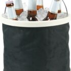 A black bucket filled with ice holds six brown beer bottles with silver caps. A metal handle is attached to the bucket.