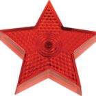Red translucent star with a textured surface and a central circular detail. The star shape is five-pointed and appears to be made of plastic or glass, with raised edges and a glossy finish.