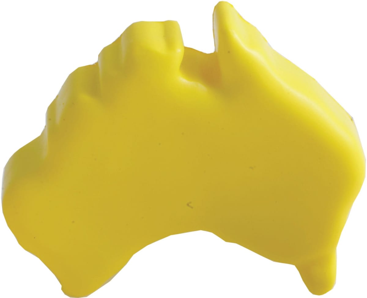 A yellow object shaped like the outline of Australia, resembling a piece of plastic or rubber.