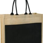 A jute tote bag with black handles and a large black front pocket. The bag is rectangular and made of a natural beige material, creating a contrast with the solid black panel and handles.