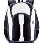 A black and white backpack with multiple pockets and zippers, featuring padded shoulder straps. A round emblem is on the side. The backpack has a sleek, modern design against a white background.