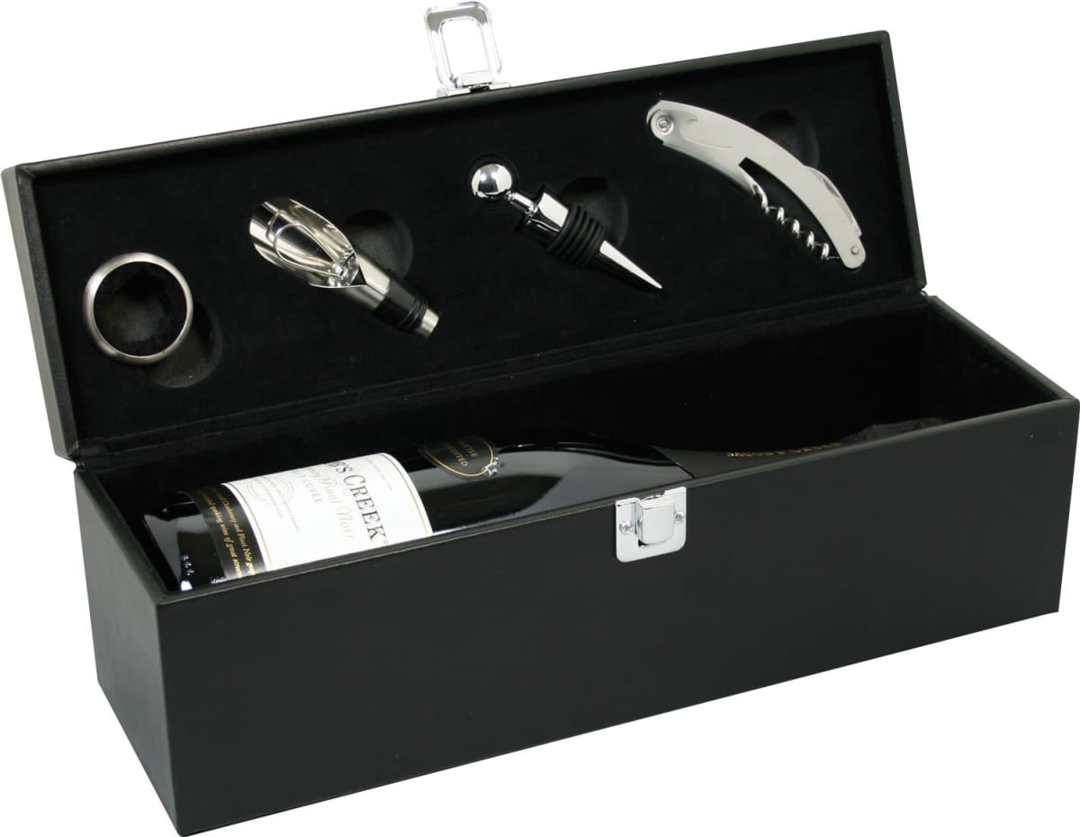 A black wine gift box containing a wine bottle and accessories: a corkscrew, a bottle stopper, a wine pourer, and a drip ring. The box has a metal latch and organized compartments for each item.