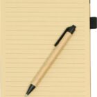 A spiral-bound notebook with lined beige pages lies open. A brown pen with a black clip rests diagonally across the pages.