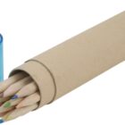 A set of colored pencils with natural wood finishes is partially visible in a cardboard tube. Next to the tube is a small blue plastic pencil sharpener with a clear casing.