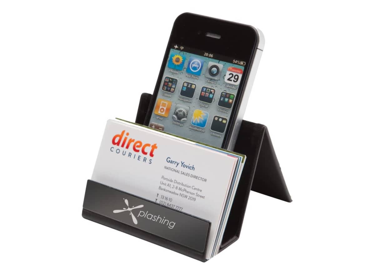 A smartphone sits in a black stand, displaying app icons on its screen. In front of it, there are business cards with a direct couriers logo. The stand is labeled with Xplashing.