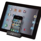 A smartphone and a tablet are displayed on a stand. The tablet screen shows app icons on a water droplet background, and the smartphone displays a home screen with various apps. The stand is branded with the text xPlashing.