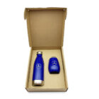 Open cardboard box containing a blue stainless steel water bottle and a matching blue travel mug. Both items feature a silver car logo. The box is plain brown, and the items are arranged side by side.