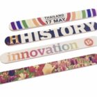 Four colorful bookmarks with various designs: one with Thailand 17 May, another saying HISTORY, the third with innovation 15, and the last featuring Tulip Time with a phone number, over a floral background.