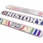 Three colorful badges with text: the first says innovation 15, the second says HISTORY, and the third says THAILAND 17 MAY with a rainbow design.