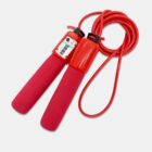 Red jump rope with digital counter on one handle. The handles have soft red grips, and the long red rope is coiled beside them, set against a light gray background.
