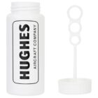 White bubble bottle with Hughes Aircraft Company printed on it. The cap is removed, showing a bubble wand with three circular loops next to it.