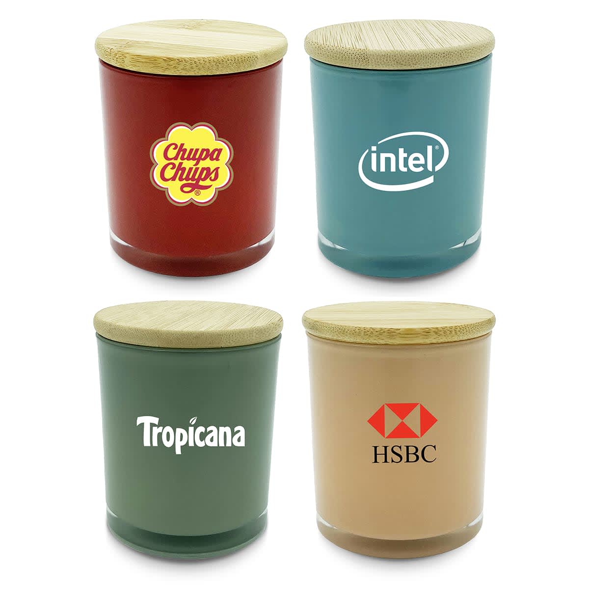 Four jars with wooden lids, each labeled with a different brand: a red jar with a yellow and red logo, a blue jar with a white logo, a green jar with a white logo, and a beige jar with a red and white logo.