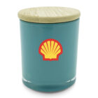 A teal jar with a bamboo lid features a yellow and red shell logo on the front.